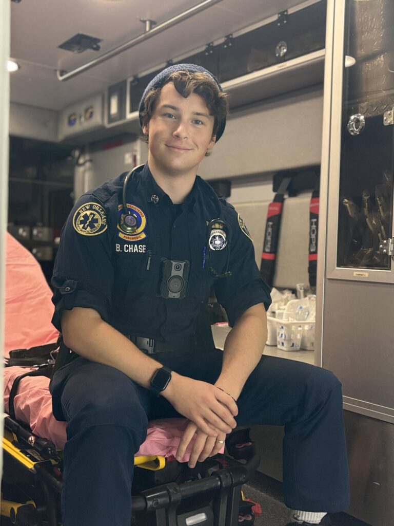 photo of Brendan Chase sitting in the back of an emergency vehicle